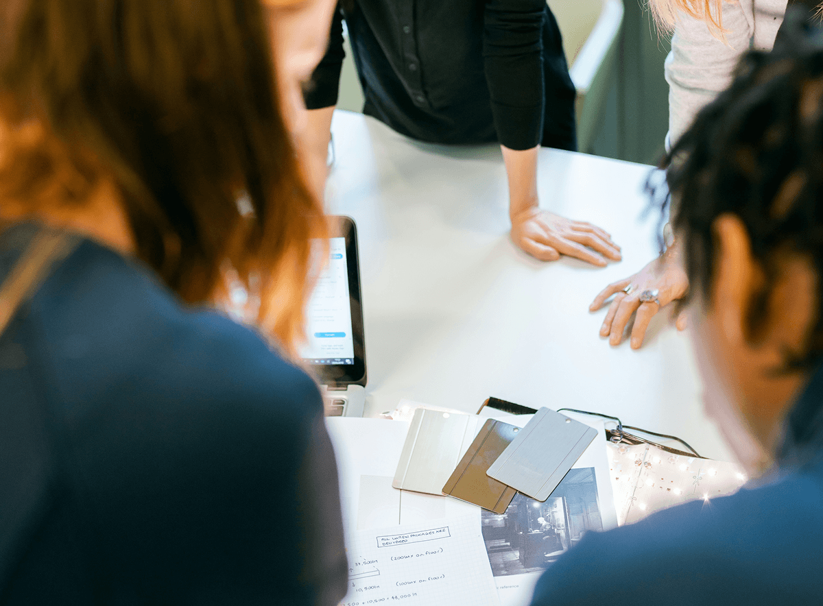 Middle of a meeting with people around a table discuss ideas